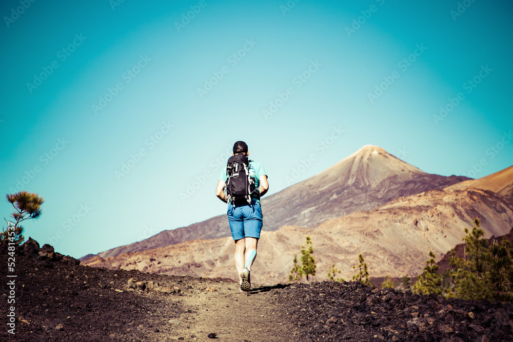 man hiking towards the volcano in El Teide national park Tenerife man hiking towards the volcano in El Teide national park Tenerife