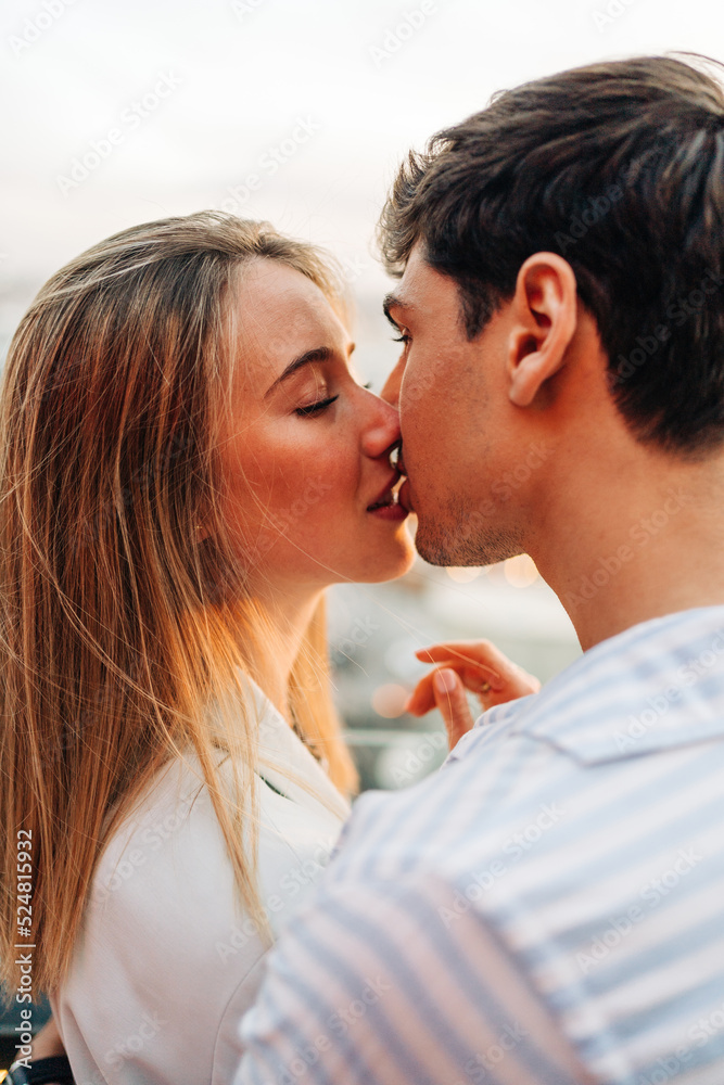 Loving couple kissing in rooftop cafe Loving couple kissing in rooftop cafe