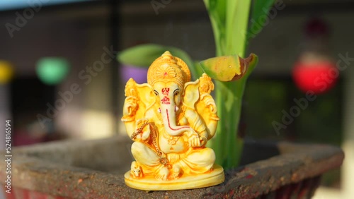 Golden lord ganesha sculpture on home background. People celebrate lord ganesha festival. photo