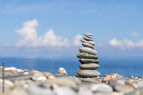 Rock balancing on ocean beach