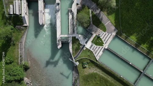 Small hydro power dam on Rhone river in Swiss Alps. Generating green energy. Power station. Drone view in summer day