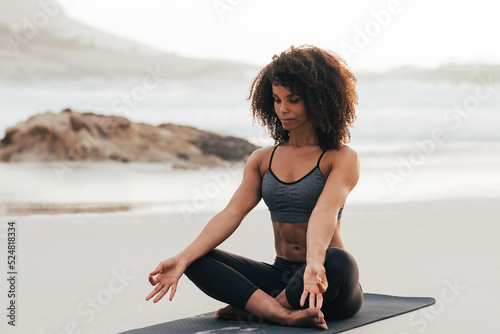 Fotografie, Tablou Woman with closed eyes doing yoga asana meditation on the beach