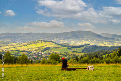 Młoda kobieta siedząca w górach patrząca na piękny krajobraz 