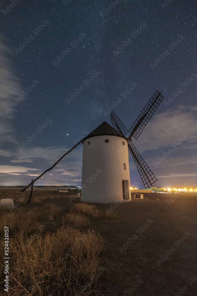 Windmills on meadow on starry night Windmills on meadow on starry night
