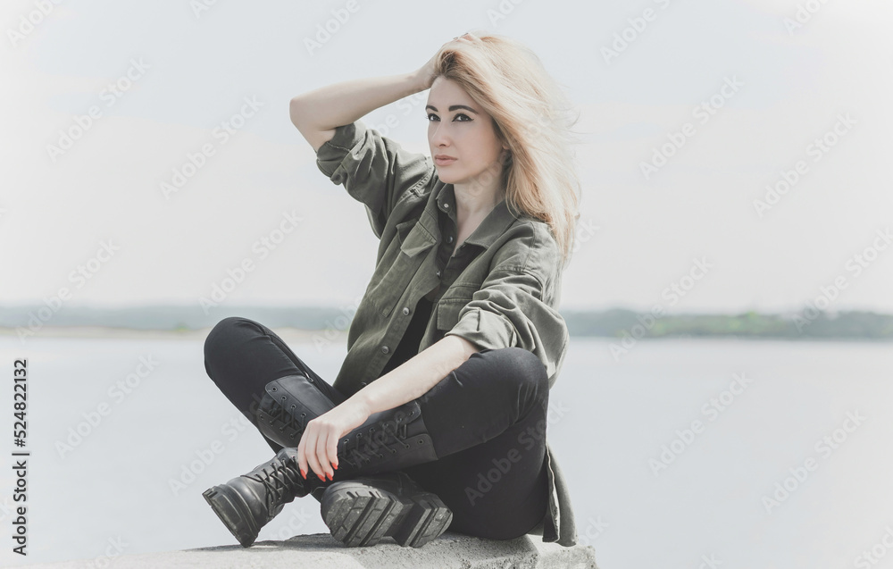 Modern blonde woman mix race in jeans jacket, fashionable details on a model, concept of trend in wardrobe