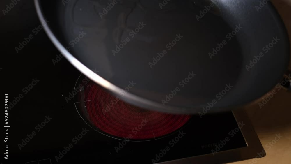 Sauteed chicken liver with onions recipe - STEP 1: sunflower oil heating in a pan. Red circle of electric stove. Lifting up and moving the pan. Kitchen, lunch or dinner, step by step cooking concept. Sauteed chicken liver with onions recipe - STEP 1: sunflower oil heating in a pan. Red circle of electric stove. Lifting up and moving the pan. Kitchen, lunch or dinner, step by step cooking concept.