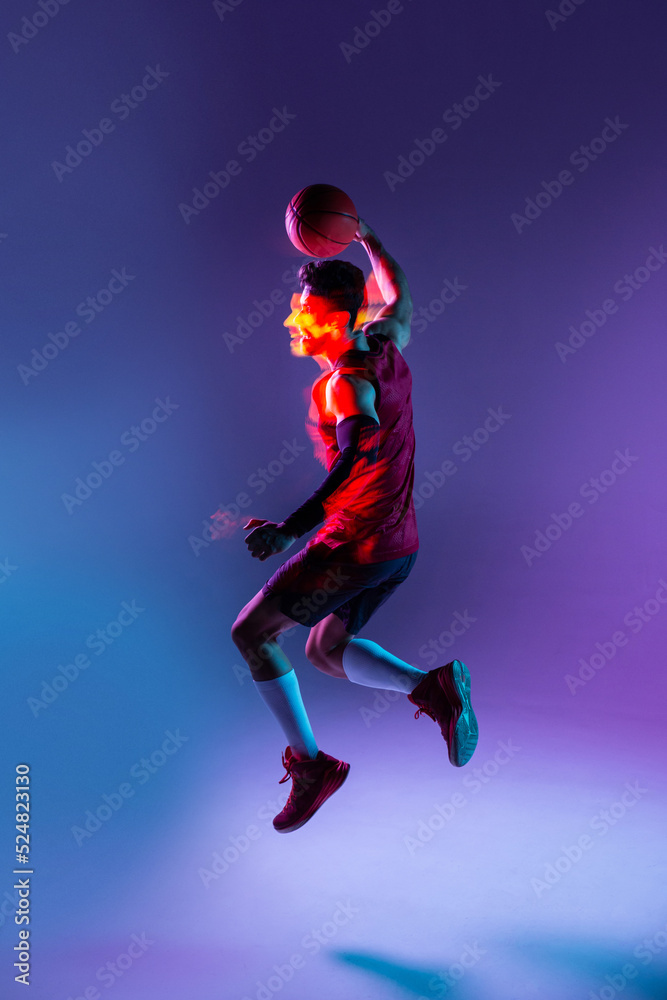 Studio Shot Of Basketball Player In The Studio with purple background Studio Shot Of Basketball Player In The Studio with purple background