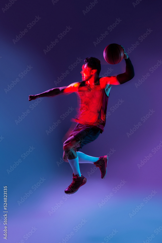 Studio Shot Of Basketball Player In The Studio with purple background Studio Shot Of Basketball Player In The Studio with purple background
