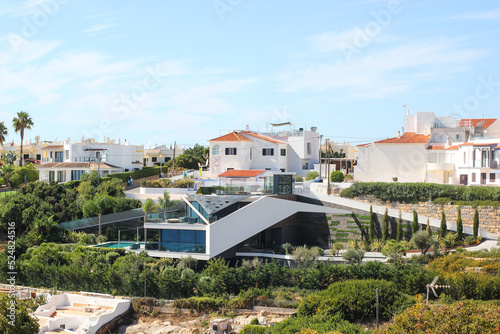 modern green house among the traditional houses