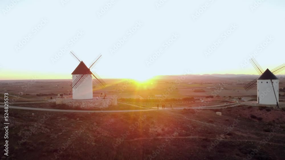 Relaxing aerial view of four windmills at sunset