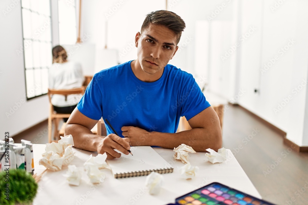 Paint student man stressed painting at art school. Paint student man stressed painting at art school.