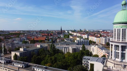 Tower round roof. Petersburger str. street, BersarinplatzDaring aerial view very close passing flight drone footageof berlin frankfurter Tor at summer 2022. photo