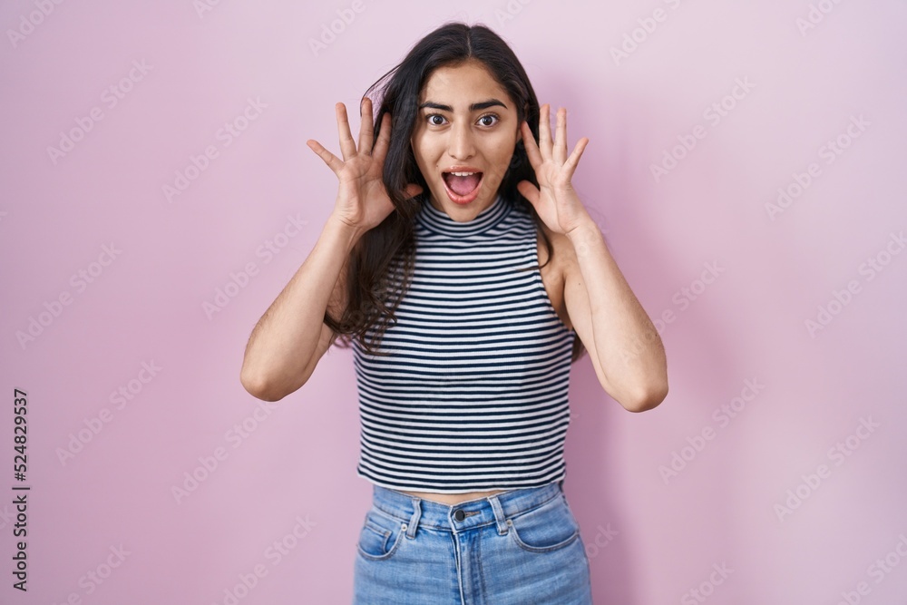 Young teenager girl wearing casual striped t shirt celebrating crazy and amazed for success with arms raised and open eyes screaming excited. winner concept Young teenager girl wearing casual striped t shirt celebrating crazy and amazed for success with arms raised and open eyes screaming excited. winner concept