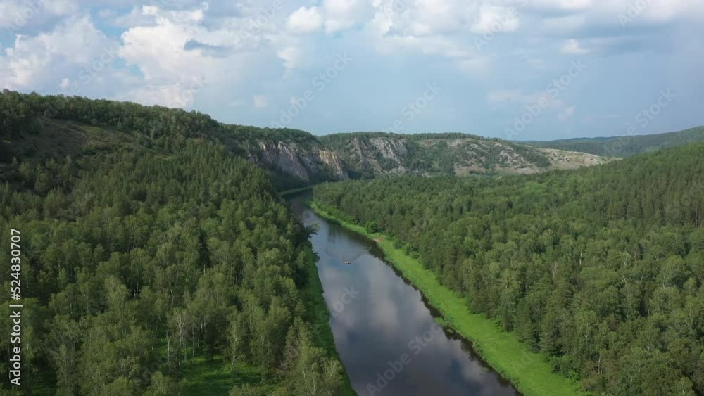Scenic aerial view of river Agidel among green forest in summer. Nature of Burzyan district of Republic of Bashkortostan