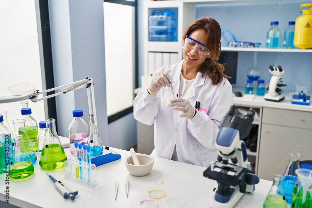 Young latin woman wearing scientist uniform working at laboratory Young latin woman wearing scientist uniform working at laboratory