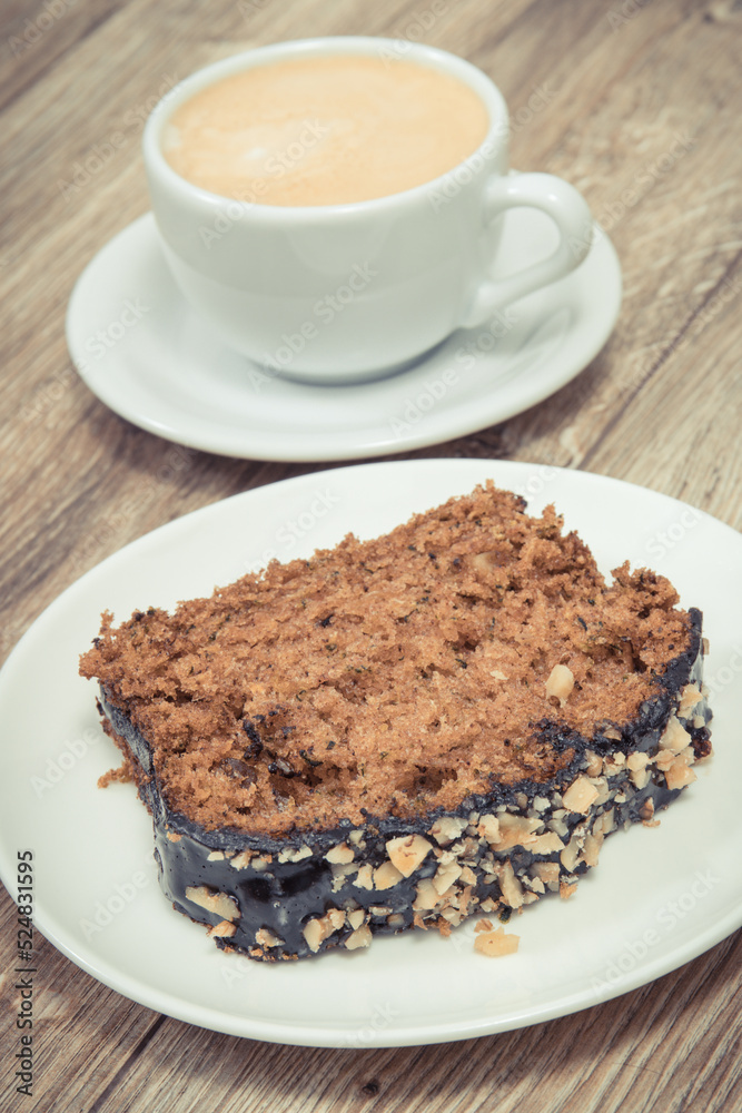 Fresh baked pastry made of zucchini and cup of white coffee. Delicious dessert Fresh baked pastry made of zucchini and cup of white coffee. Delicious dessert
