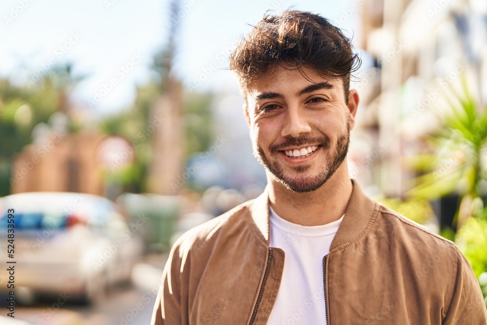 Young hispanic man smiling confident standing at street Young hispanic man smiling confident standing at street