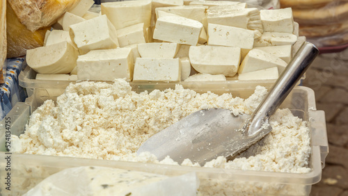 Fresh homemade cottage cheese and cheese are sold at the street market. Close-up