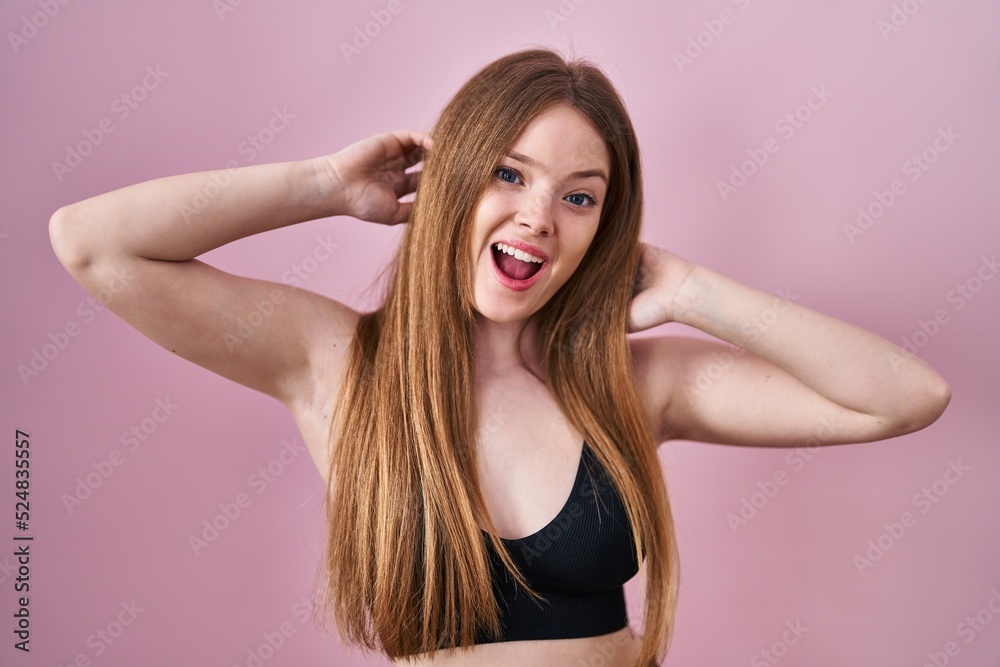 Young caucasian woman wearing lingerie over pink background afraid and shocked with surprise and amazed expression, fear and excited face.