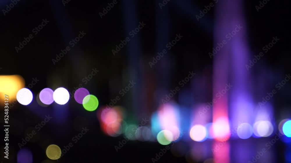 Blur bokeh Waterworks at the night on the water surface, decorated and played color by lighting spot light.
