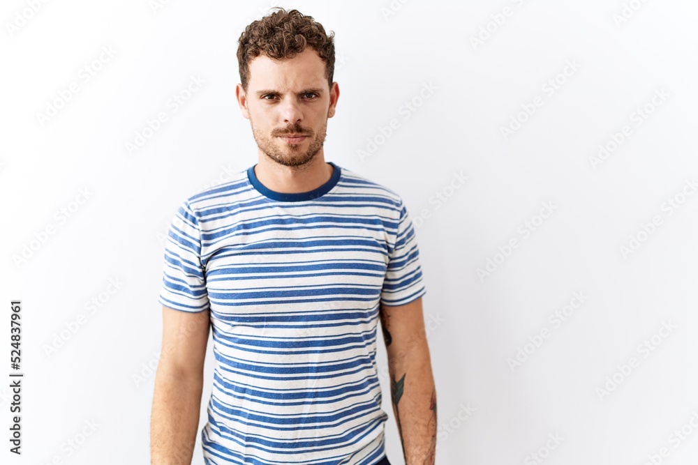 Handsome young man standing over isolated background skeptic and nervous, frowning upset because of problem. negative person. Handsome young man standing over isolated background skeptic and nervous, frowning upset because of problem. negative person.