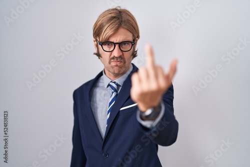 Caucasian man with mustache wearing business clothes showing middle finger  impolite and rude fuck off expression