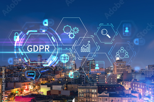 Roof top panoramic city view of San Francisco at night time, midtown skyline, California, United States. GDPR hologram, concept of data protection regulation and privacy for all individuals