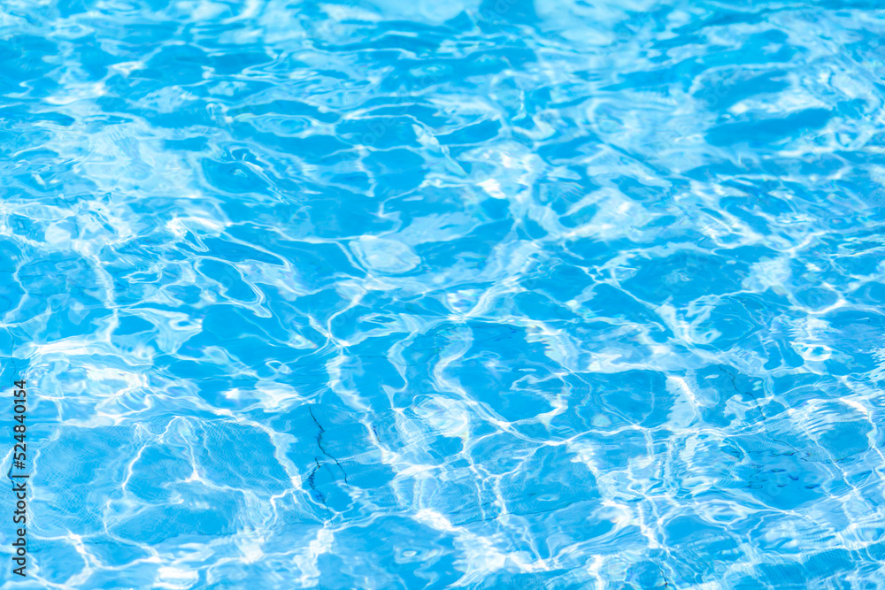 Water background, ripple and flow with waves. Summer blue swiming pool pattern. Sea, ocean surface. Overhead top view with place for text.