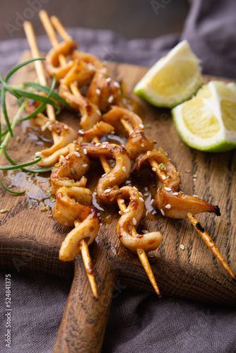 Squid skewers with soy sauce and sesame seeds