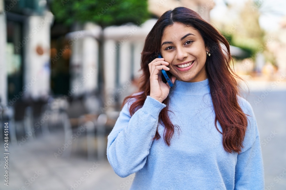 Young hispanic woman smiling confident talking on the smartphone at street Young hispanic woman smiling confident talking on the smartphone at street