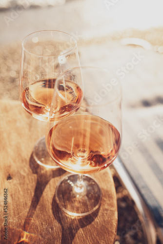 Two glasses of rose wine against the sunset sky.