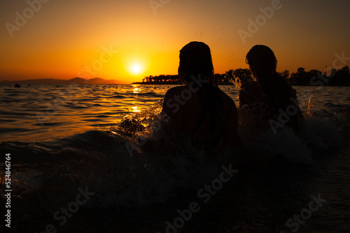 Close up happy smiling young couple two friends rest together at sunrise over sea beach ocean outdoor seaside in summer day sunset evening.