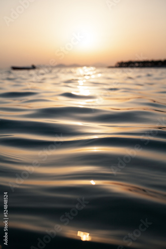 Sea and orange sky at sunset. Holiday landscape. Sun rays reflecting on the sea.  