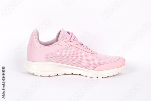 Light pink running sports shoe on white background. Running shoe, sneaker or trainer. Women's athletic shoe. fitness, sport, training concept.