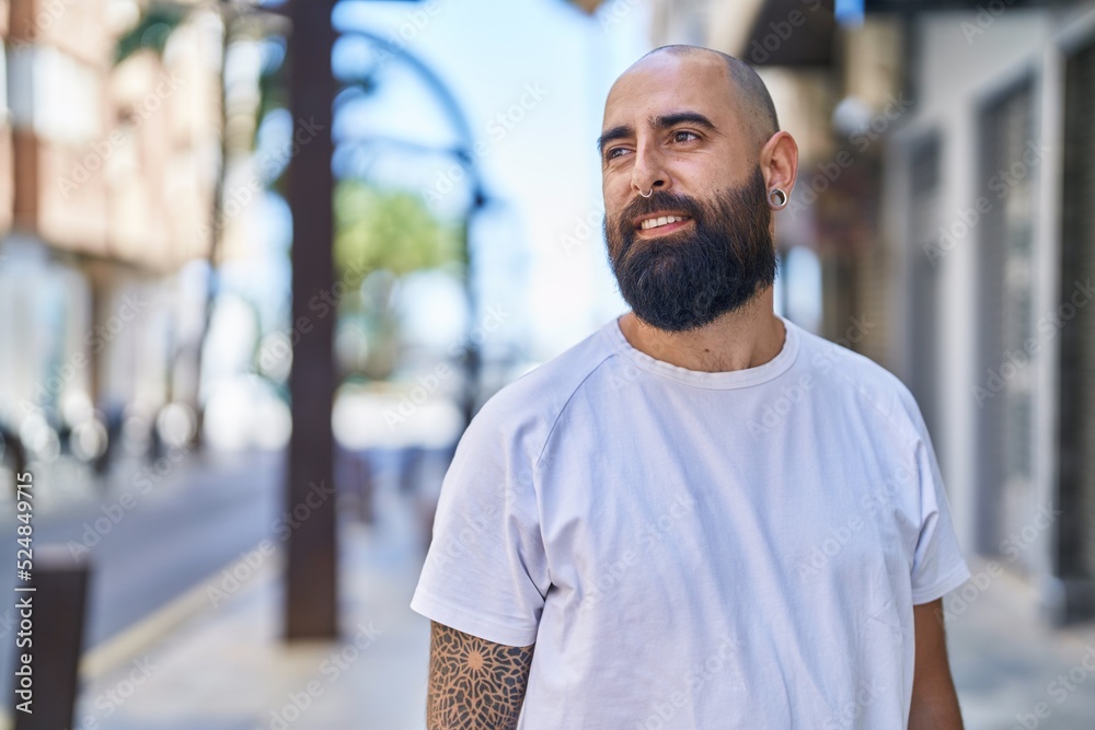 Young bald man smiling confident looking to the side at street Young bald man smiling confident looking to the side at street