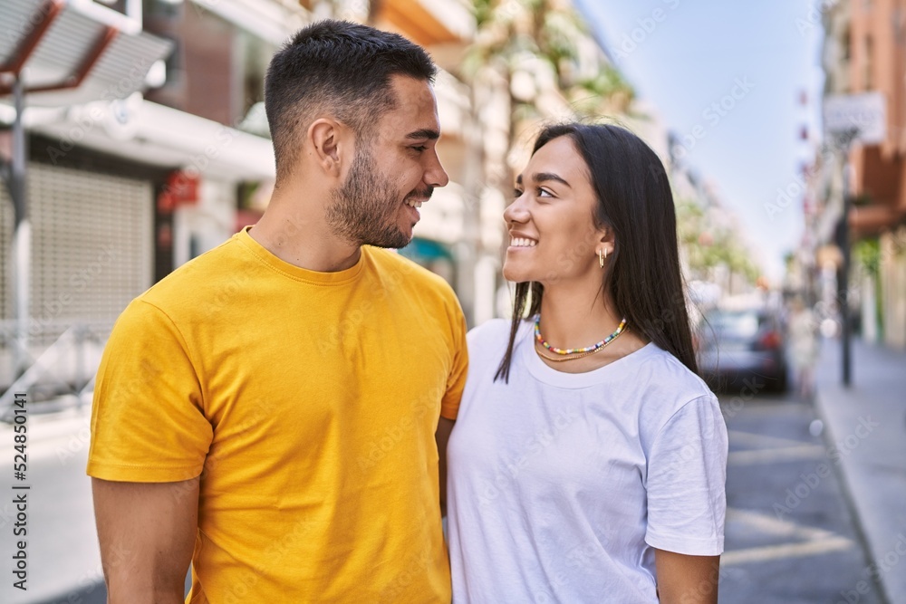 Young latin couple smiling happy and hugging standing at the city. Young latin couple smiling happy and hugging standing at the city.