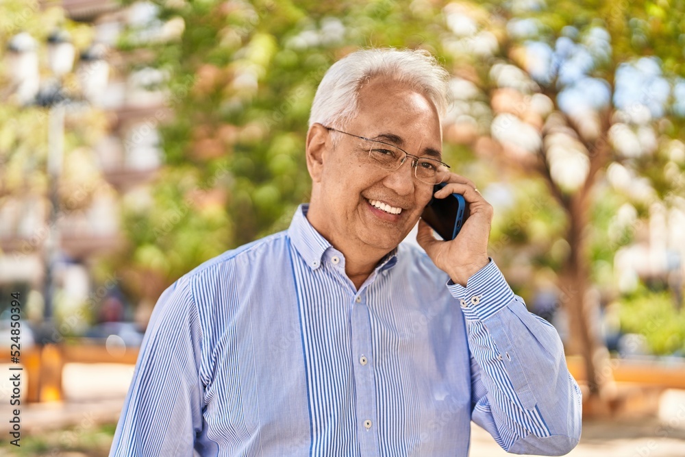 Senior man smiling confident talking on the smartphone at park Senior man smiling confident talking on the smartphone at park