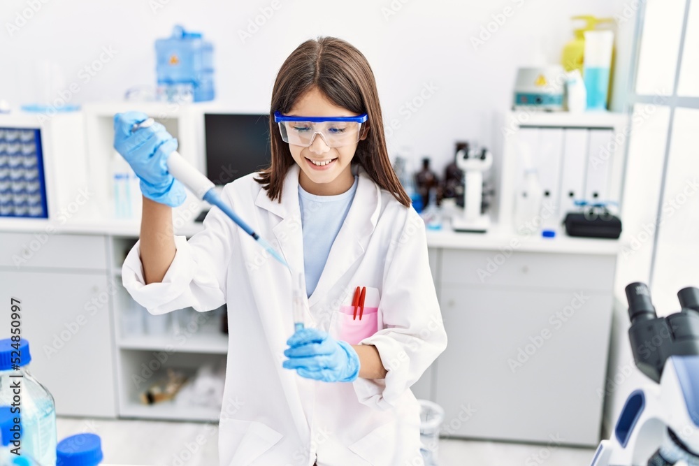 Young hispanic girl working using pipette at laboratory Young hispanic girl working using pipette at laboratory