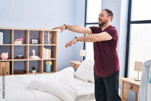 Young hispanic man somnambulist sleepwalking at bedroom photo