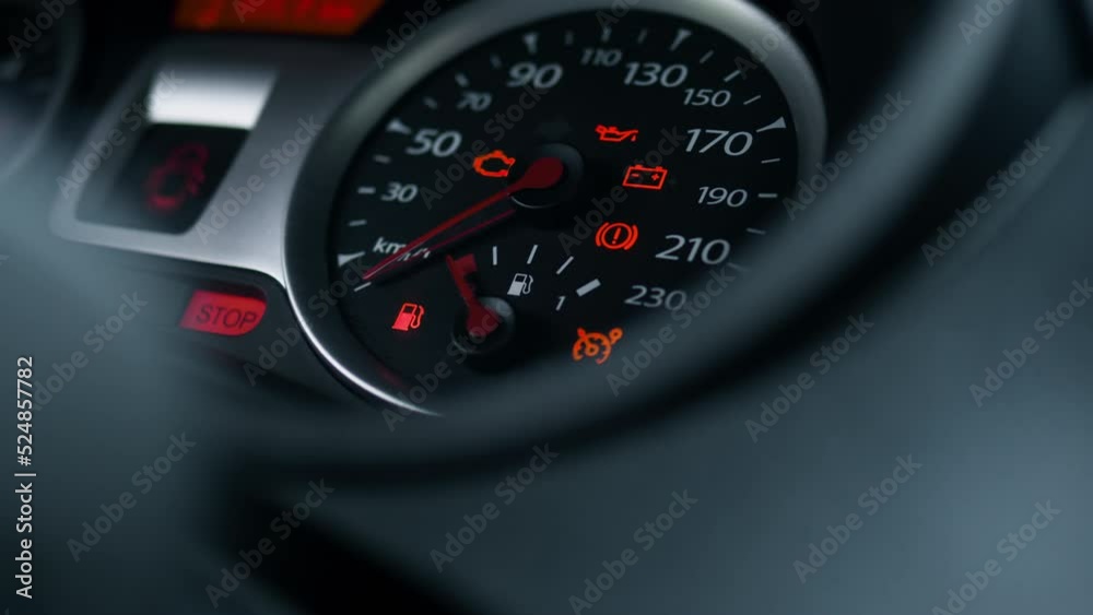 Car dashboard fuel tank arrow, fuel tank gauge, car ignition, engine start dashboard, car start ignition key. Indicator lights on the dashboard near the steering wheel of the car lit up
