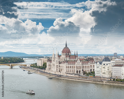 Building of the Hungarian Parliament city tram and cars in the city of Budapest.