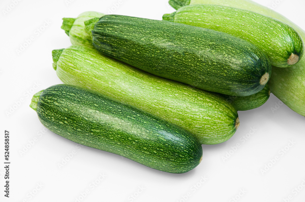fresh zucchini on a white background. delicious green vegetables on the table. appetizing zucchini on a light texture. healthy food concept fresh zucchini on a white background. delicious green vegetables on the table. appetizing zucchini on a light texture. healthy food concept