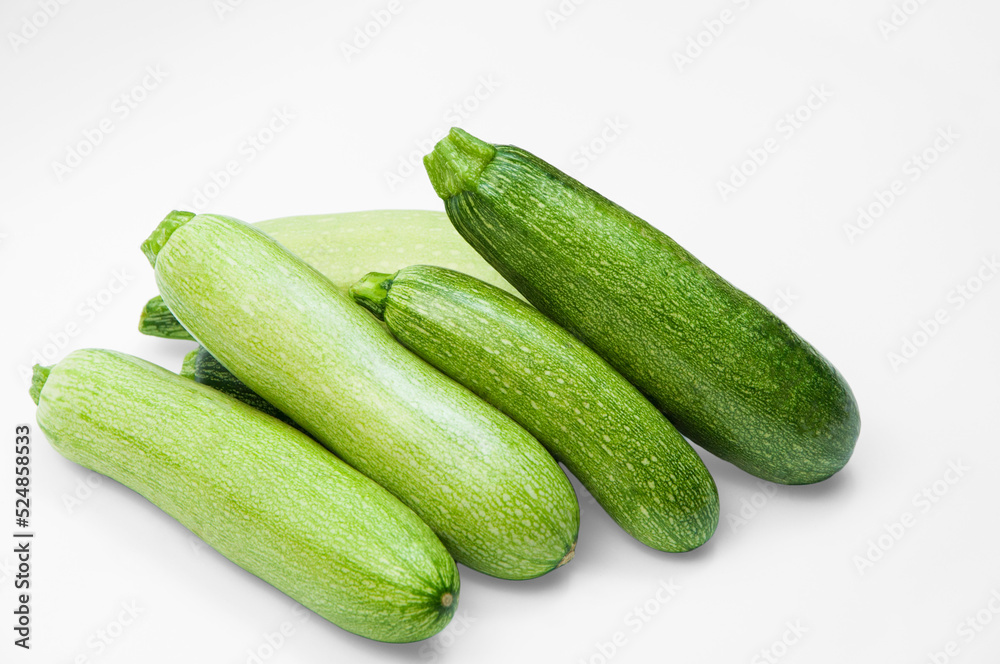 fresh zucchini on a white background. delicious green vegetables on the table. appetizing zucchini on a light texture. healthy food concept fresh zucchini on a white background. delicious green vegetables on the table. appetizing zucchini on a light texture. healthy food concept