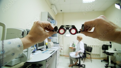 Optical eyeglass frames close-up, ophthalmologist examining patient with optometrist trial frame, visual inspection device in ophthalmological clinic,. High quality photo photo