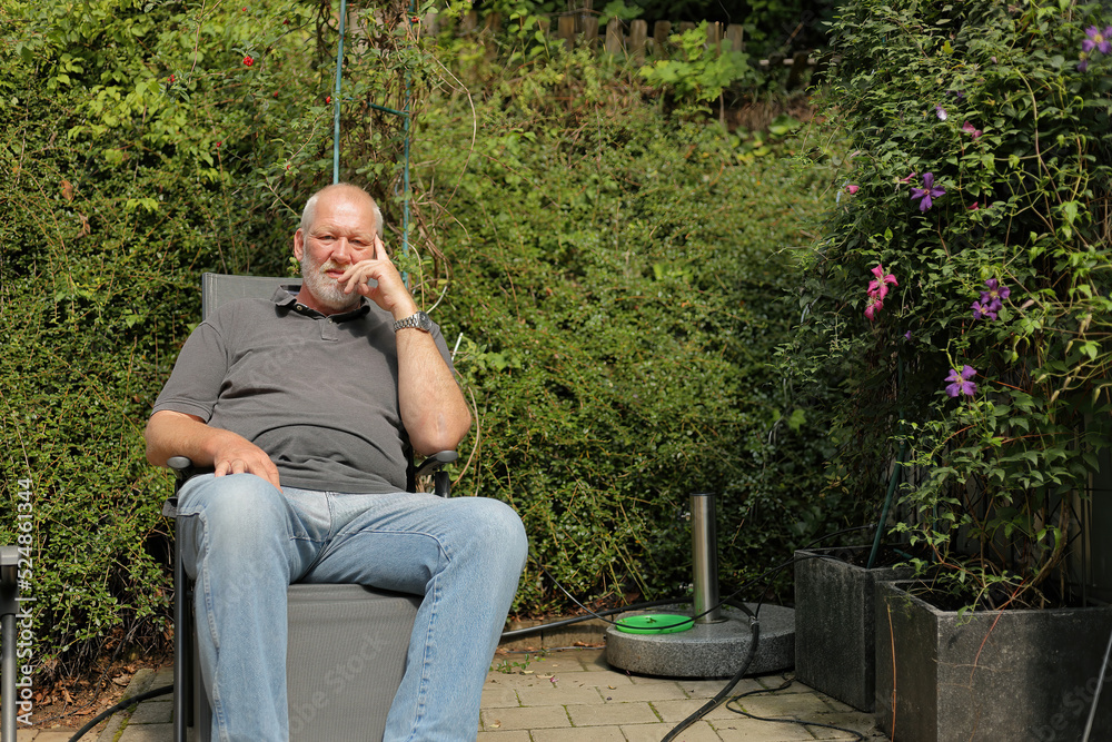 Fototapeta premium man sitting on a garden chair