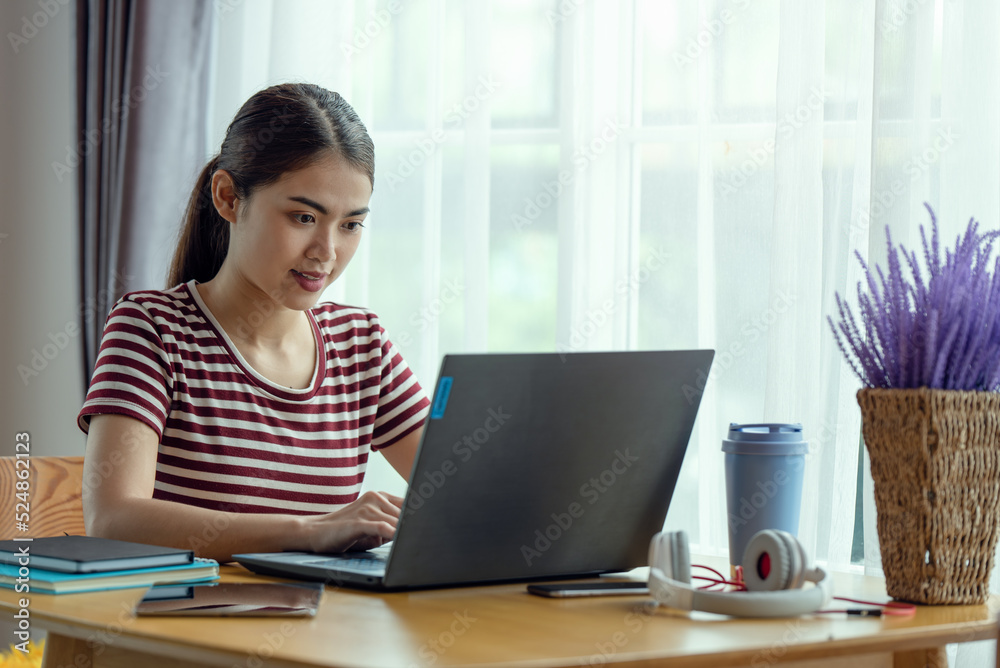 Young Asian businesswoman working at her house with laptop, working at home, business concept Young Asian businesswoman working at her house with laptop, working at home, business concept
