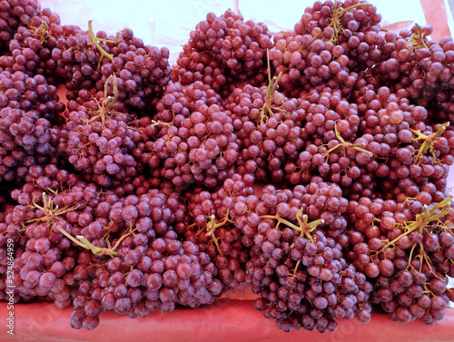 close up background photo of fresh grapes in market