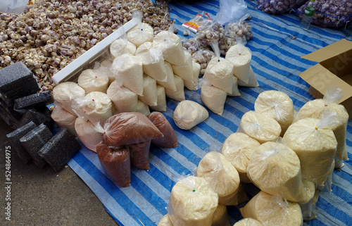 selling milled rice and garlic on street local market