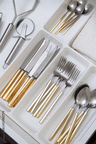 Modern kitchen, Open drawers, Set of cutlery trays in kitchen drawer. Nobody in the kitchen
