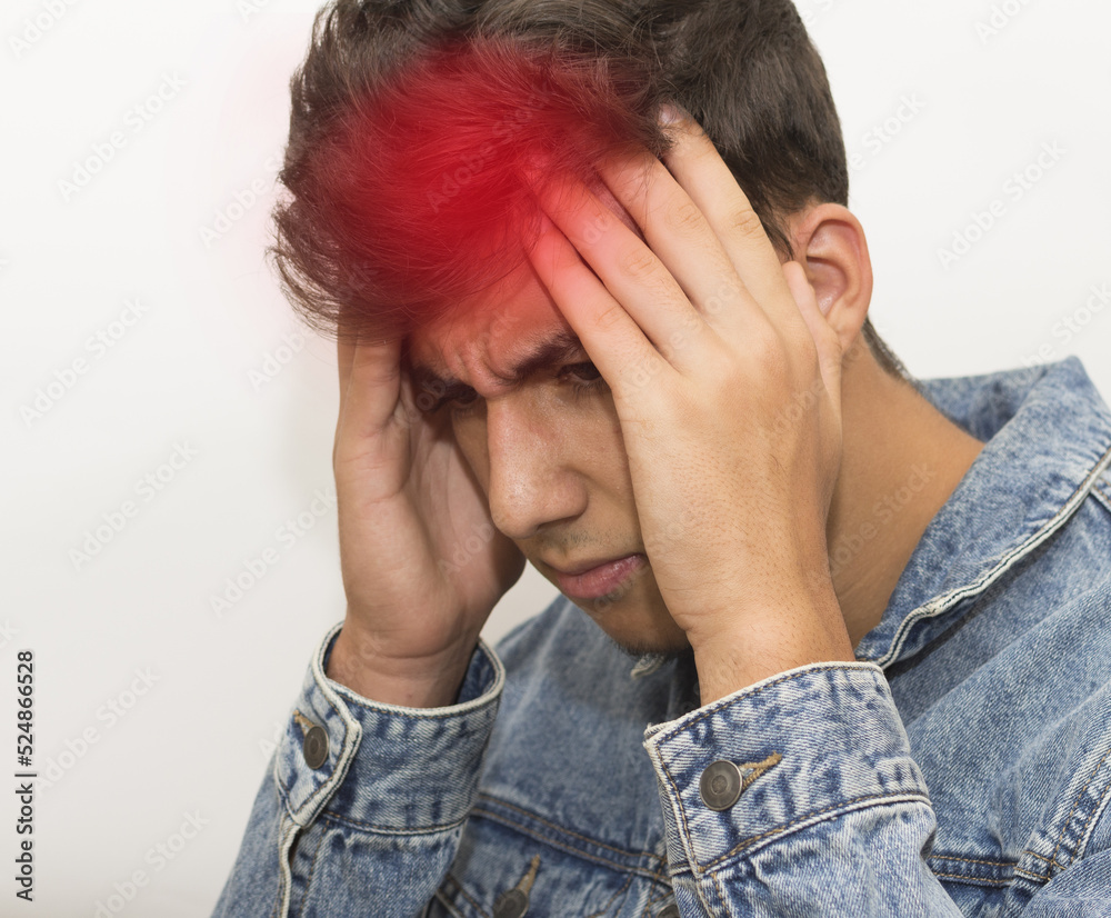 Fototapeta premium Young man suffering from headache